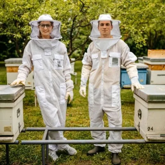 two beekeepers in protective gear