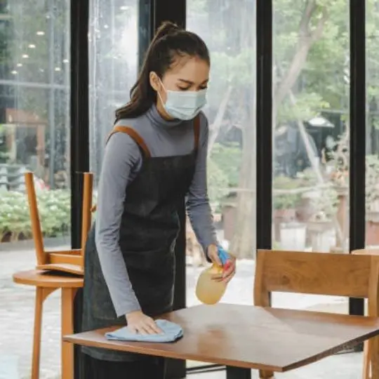 a human cleaning a table