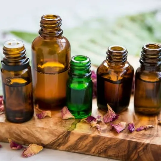 essential oils on top of a wooden surface