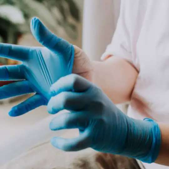human putting on rubber gloves