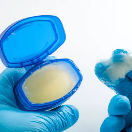 human scooping up petroleum jelly