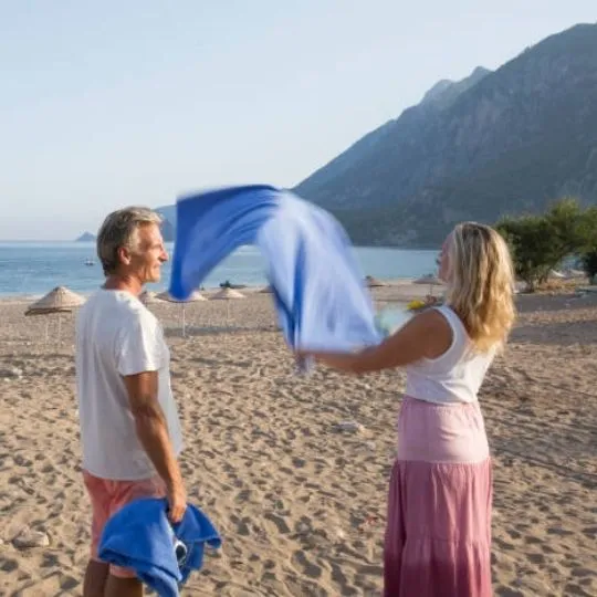 human shaking towel at the beach