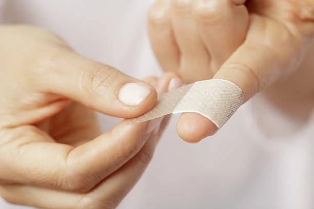 finger with wound wrapped in a bandaid