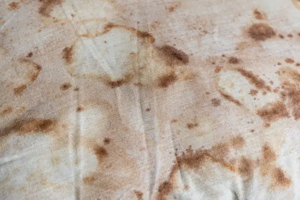 Close-up old dirty pillow with bed bug and saliva stain and fungus cause of illness
