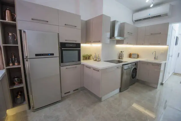 Interior design decor showing modern kitchen and appliances in luxury apartment showroom

